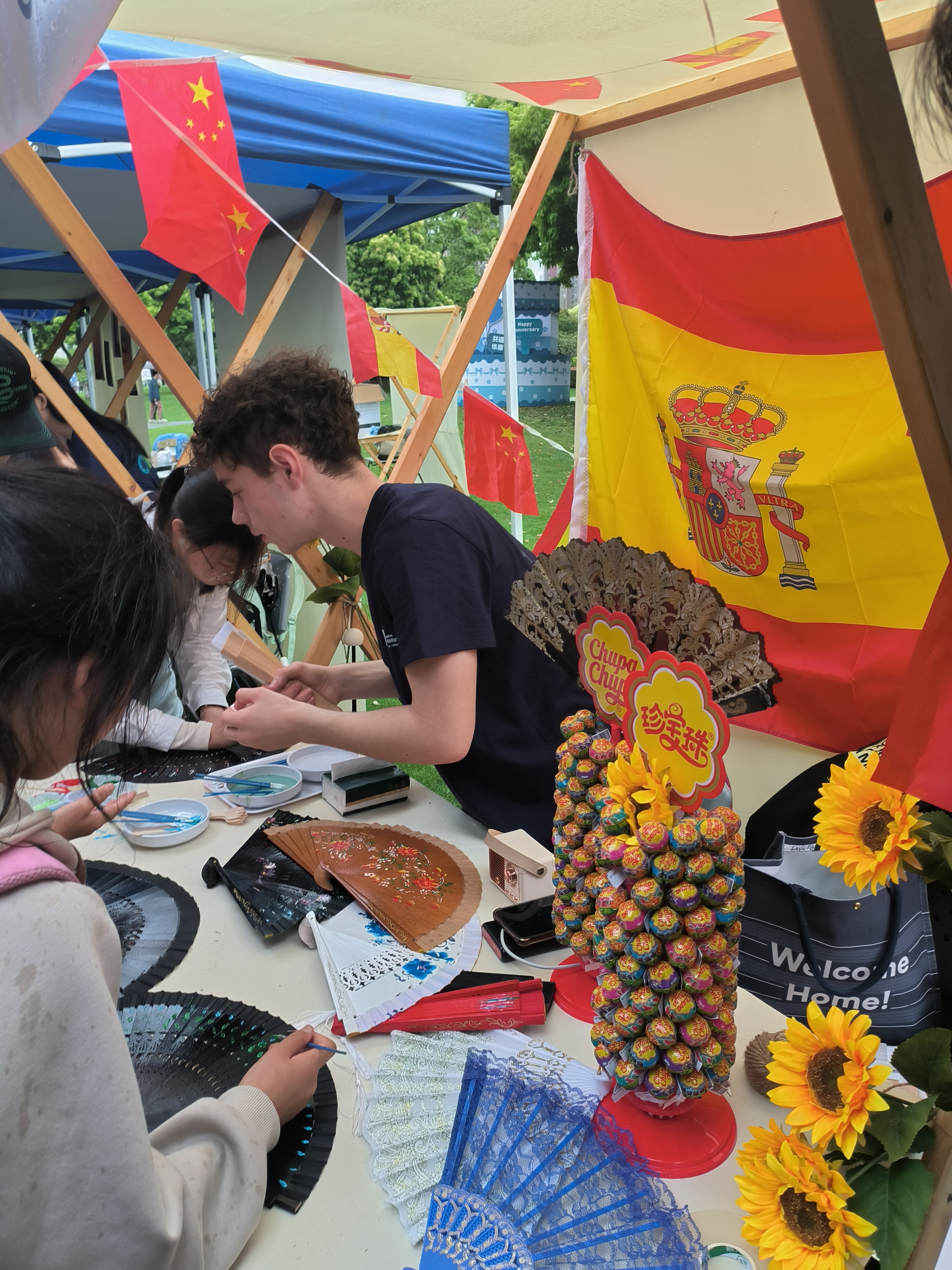 Saúl teaching how to paint fans following a traditional Spanish style.